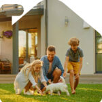 Exterior of a beautiful suburban home with a lush green lawn and a swing set, representing the dream of homeownership.
