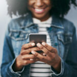Woman using F&M Bank mobile banking app to manage finances