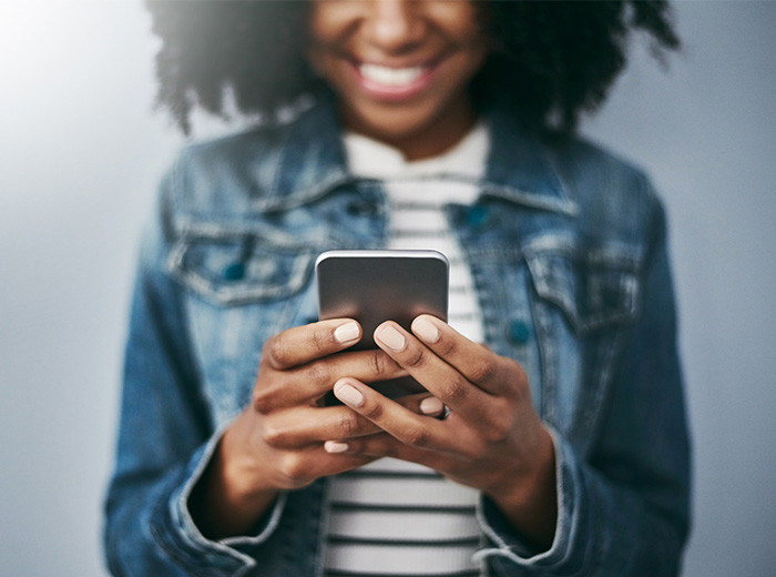 Woman using F&M Bank mobile banking app to manage finances