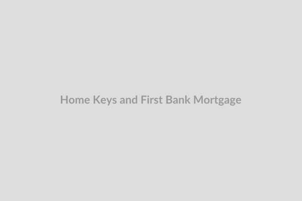 Smiling couple receiving house keys from a First Bank mortgage advisor, symbolizing home ownership and the first bank mortgage process.