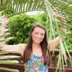 Emily's senior portrait session in Outer Banks, featuring boats at Pirates Cove