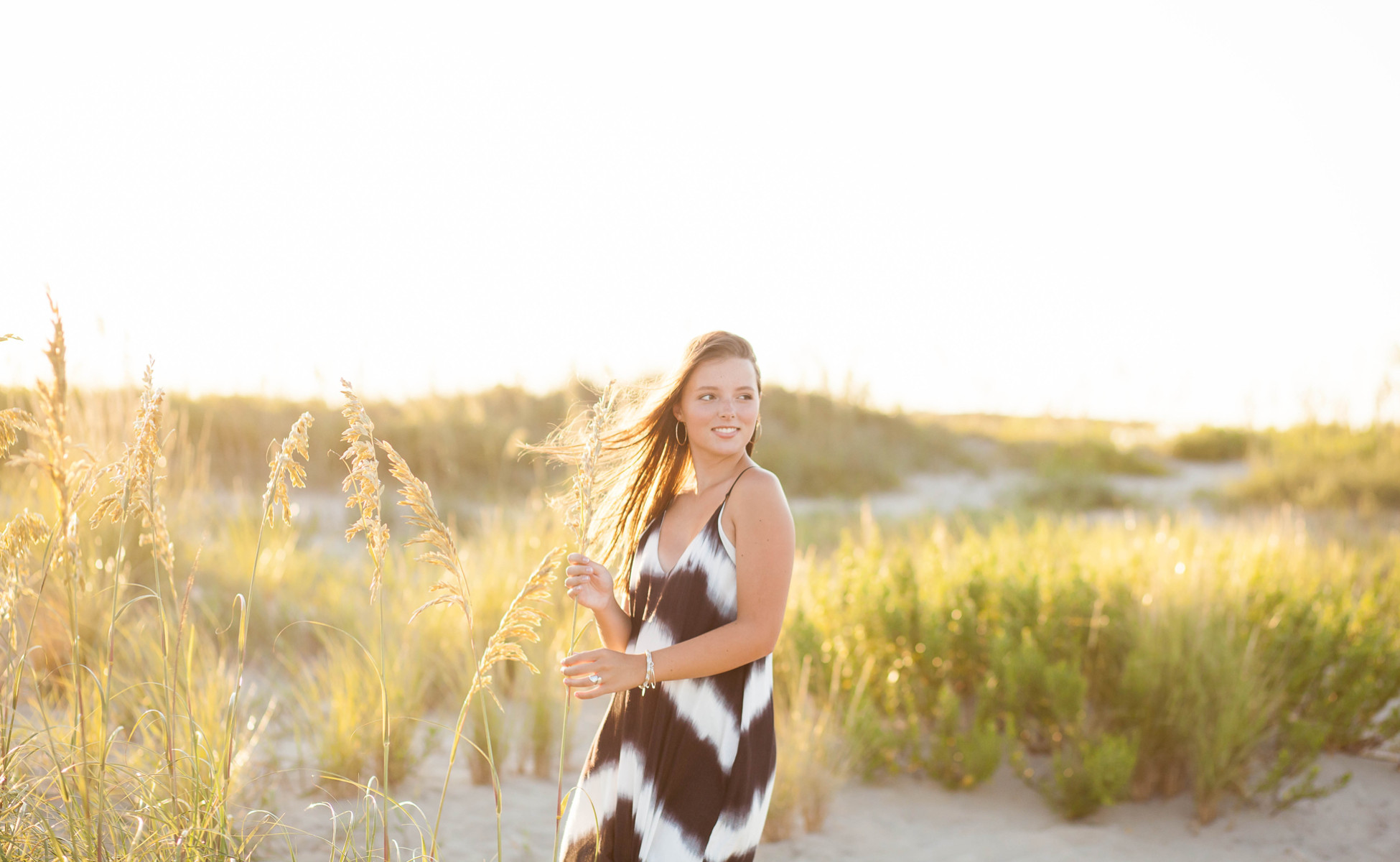 Outer Banks senior portrait photography, Emily posing with the ocean breeze