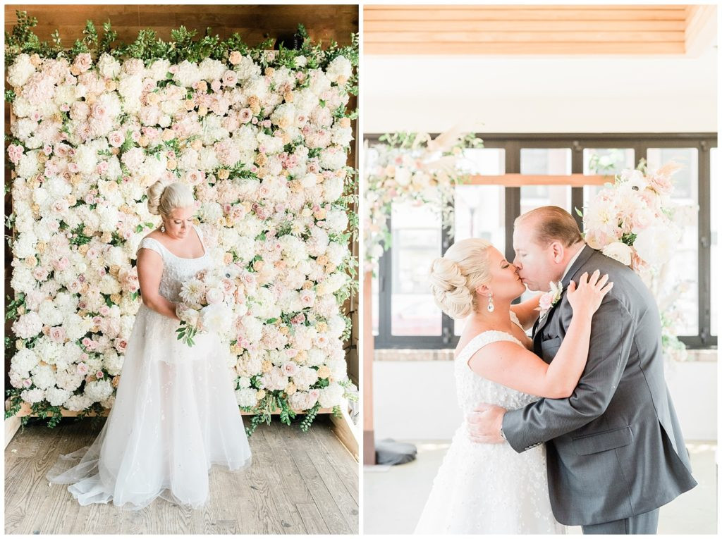 Bride standing in front of a blush and neutral flower wall at Teak Red Bank wedding.