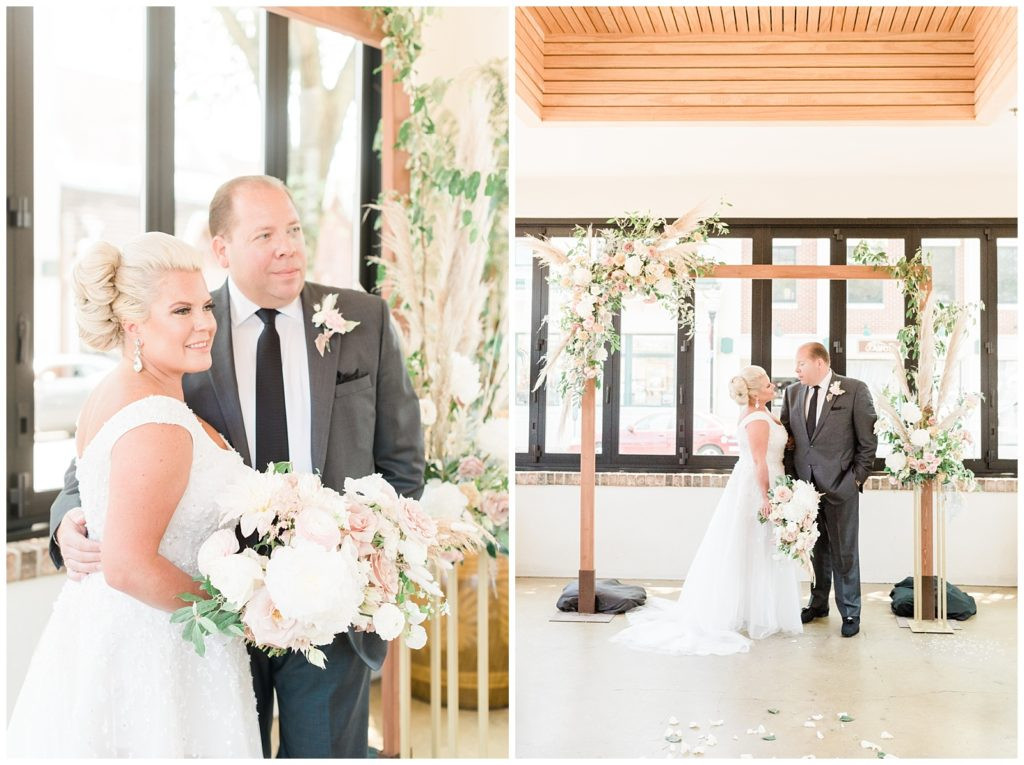 Bride and groom under the arbor in their ceremony space at Teak Red Bank.