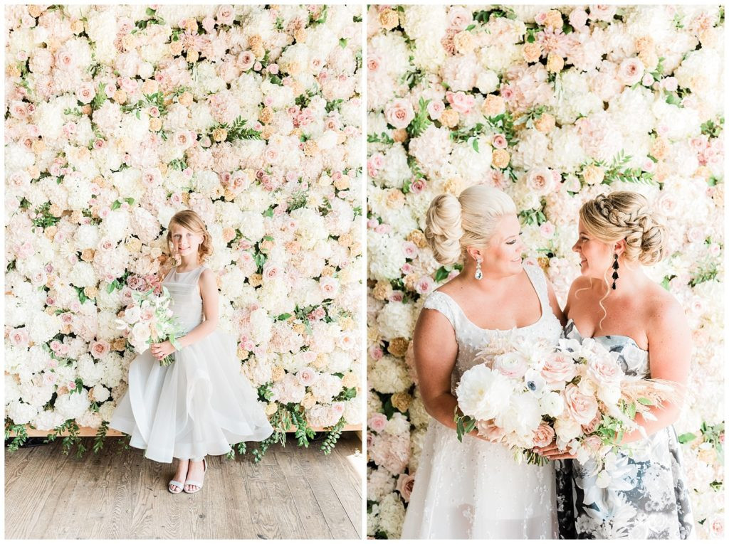 Flower girl posing in front of the flower wall at Teak Red Bank wedding reception.