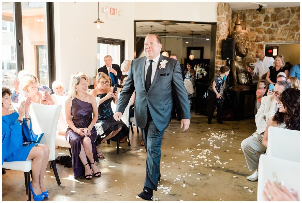 Groom walking down the aisle at his wedding ceremony at Teak in Red Bank.