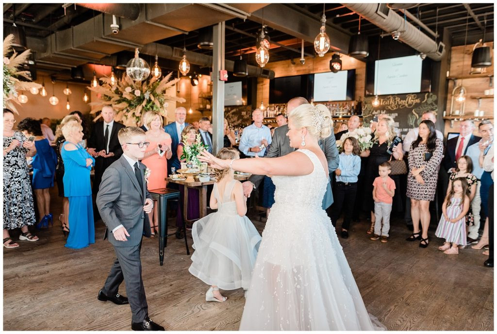 First dance as a family with bride, groom, and children at Teak Red Bank wedding.