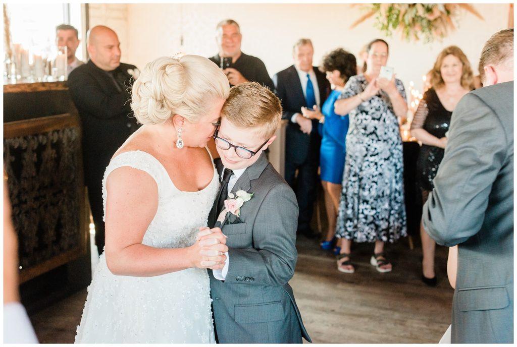 Bride dancing with her son at their family-centered wedding at Teak Red Bank.