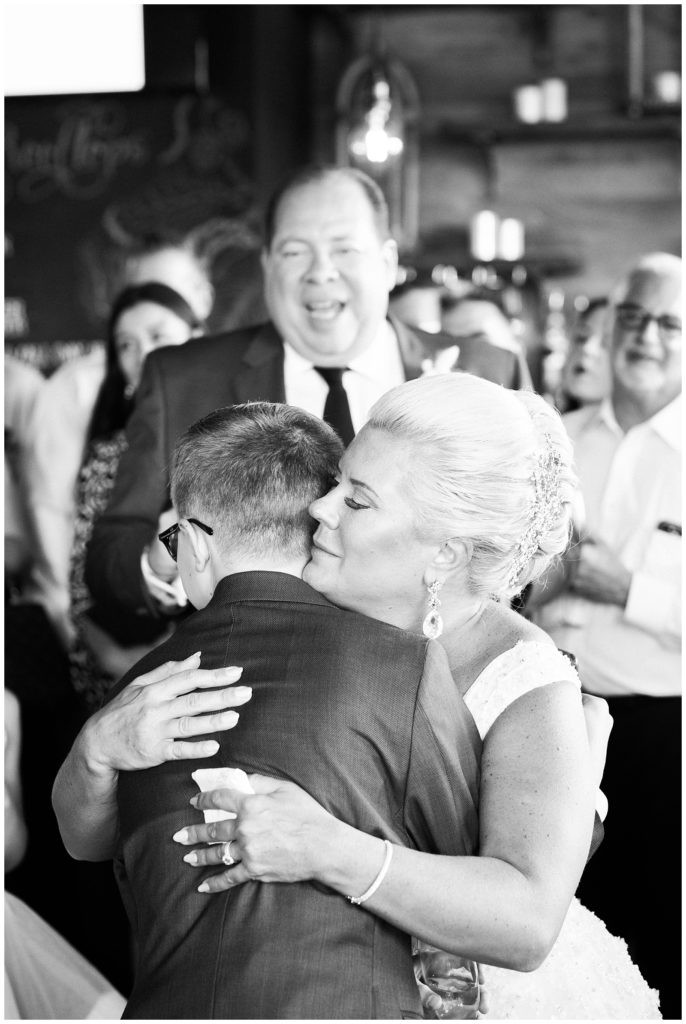 Bride hugging her son after his heartfelt toast at Teak Red Bank wedding.
