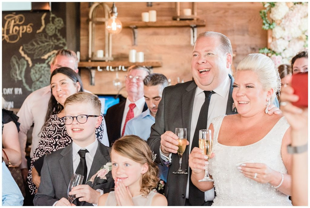 Bride and groom laughing during speeches at their Teak Red Bank wedding reception.