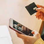 Discover debit card being swiped at a Walmart cashier for a cash deposit.