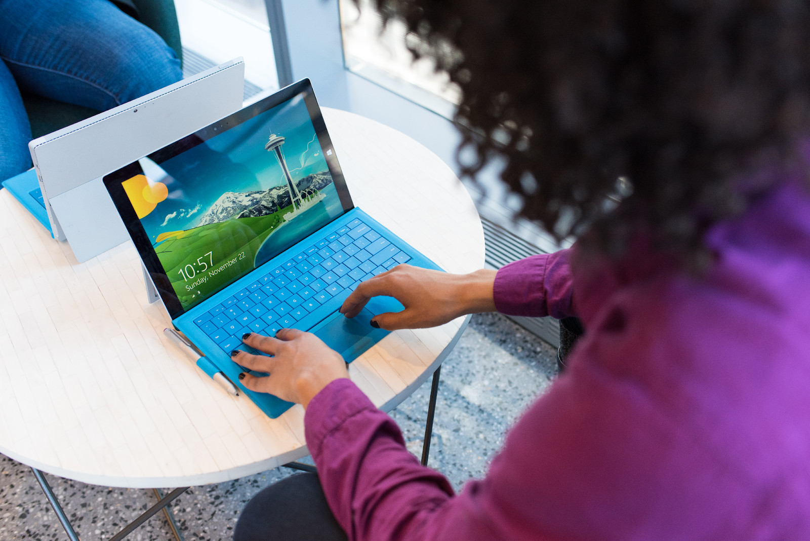 A woman using a Microsoft Surface laptop, highlighting secure online transactions