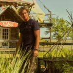 Rudy Pankow as JJ Maybank in Outer Banks, Season 4, looking thoughtfully to the side.