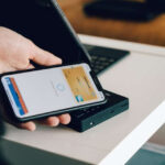 Man is paying with his phone using apple pay