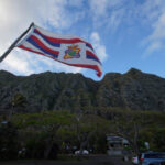 Flag flies at Kaiona Beach Park with the majestic Koolau Mountains near Waimanalo.